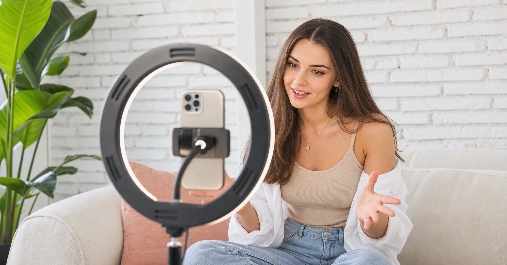 A creator recording a video with a ring light and phone